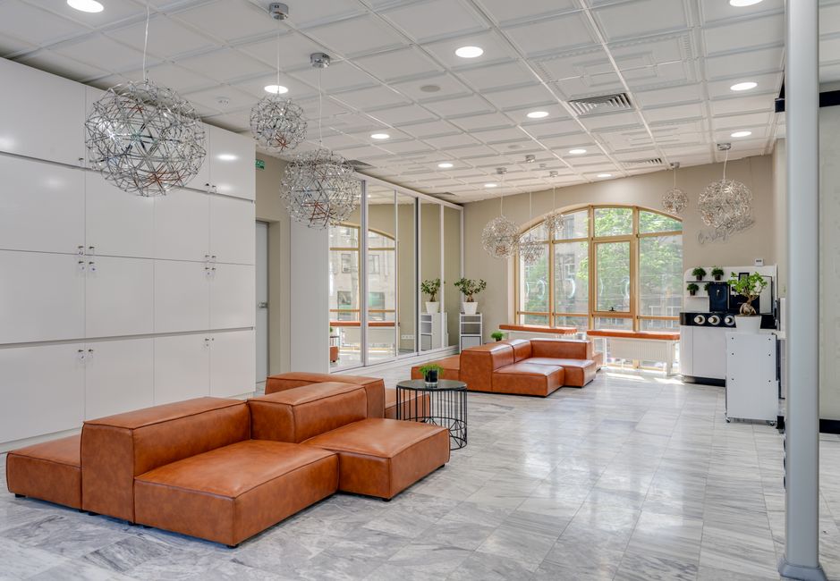 Spacious modern lounge featuring leather sofas and contemporary lighting, ideal for luxury interior design concepts.